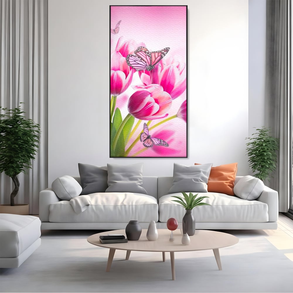 Tablou canvas cu tablou canvas cu lalele roz si fluturi, in rama de aluminiu negru, pe perete intr-un living